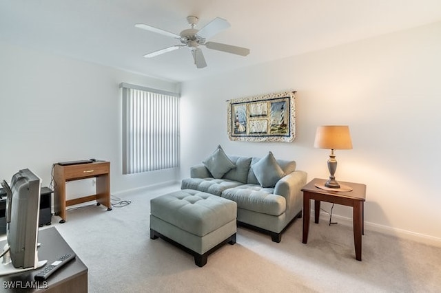 carpeted living room with ceiling fan