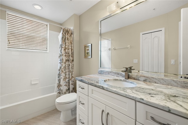 full bathroom featuring shower / bathtub combination with curtain, vanity, and toilet