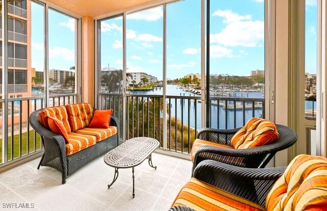 sunroom / solarium featuring a water view