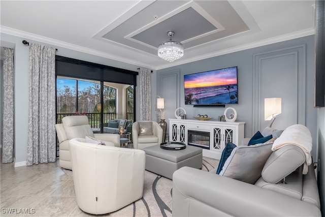 living room with a notable chandelier and ornamental molding