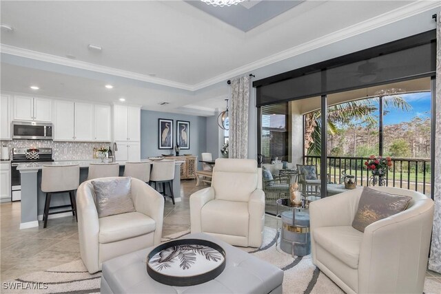 living room with a raised ceiling, light tile patterned floors, and crown molding