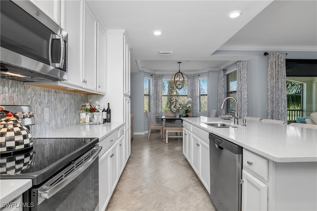 kitchen with sink, ornamental molding, tasteful backsplash, white cabinetry, and stainless steel appliances