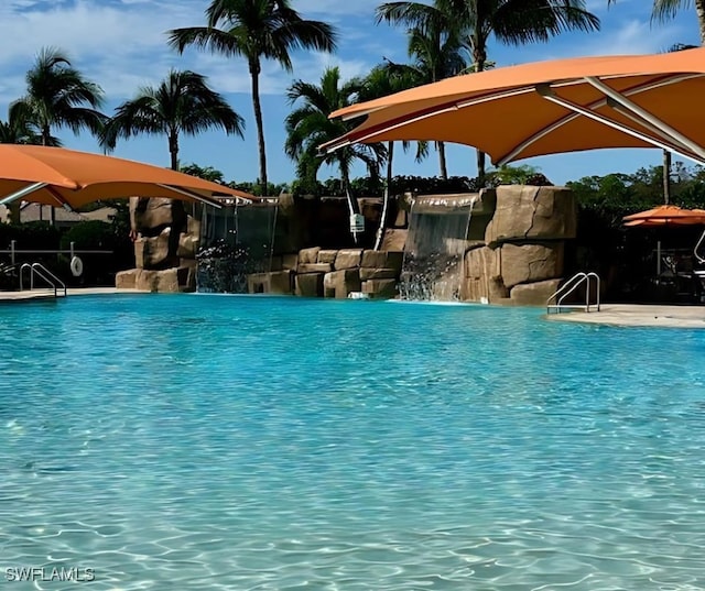 view of swimming pool featuring pool water feature