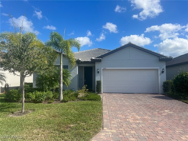 view of front of property featuring a garage and a front yard