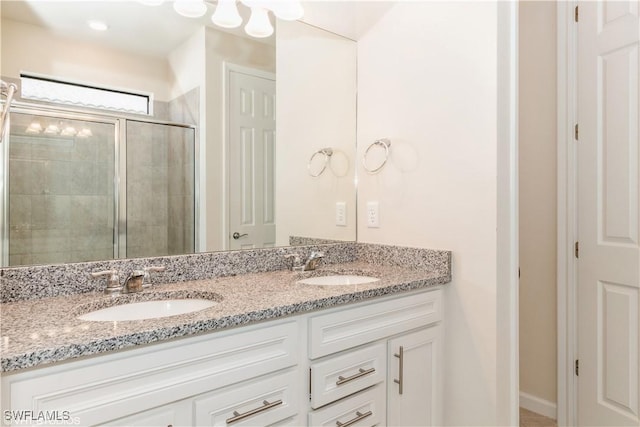 bathroom with vanity and a shower with shower door