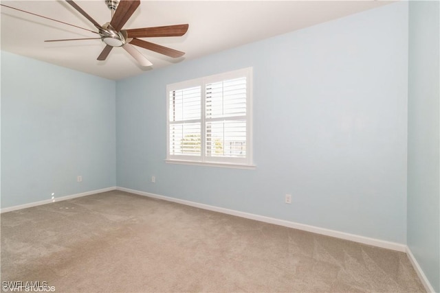 carpeted spare room with ceiling fan