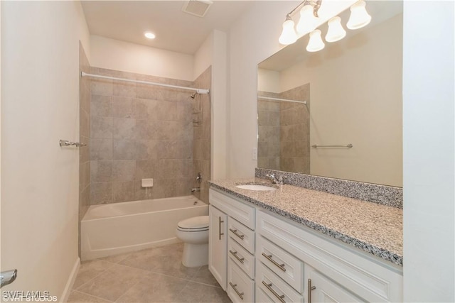 full bathroom with vanity, tiled shower / bath, tile patterned floors, and toilet