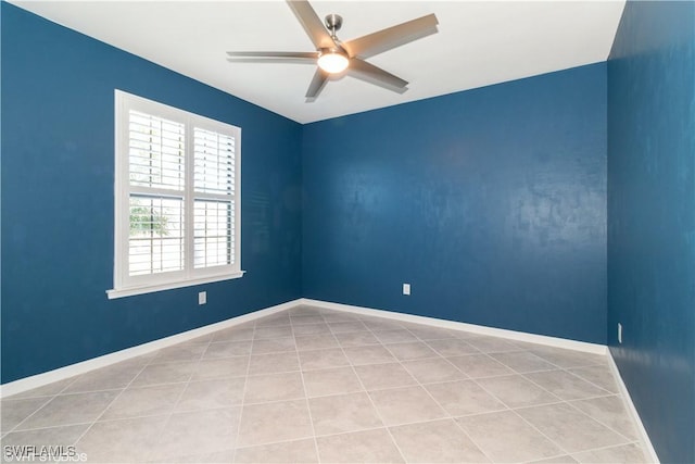 tiled spare room featuring ceiling fan