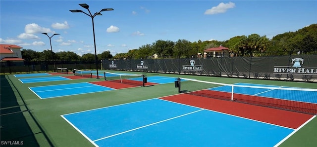 view of tennis court featuring basketball hoop