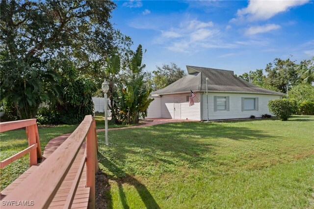 view of property exterior with a yard