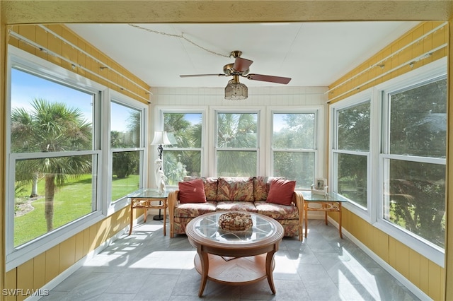 sunroom / solarium featuring ceiling fan and plenty of natural light