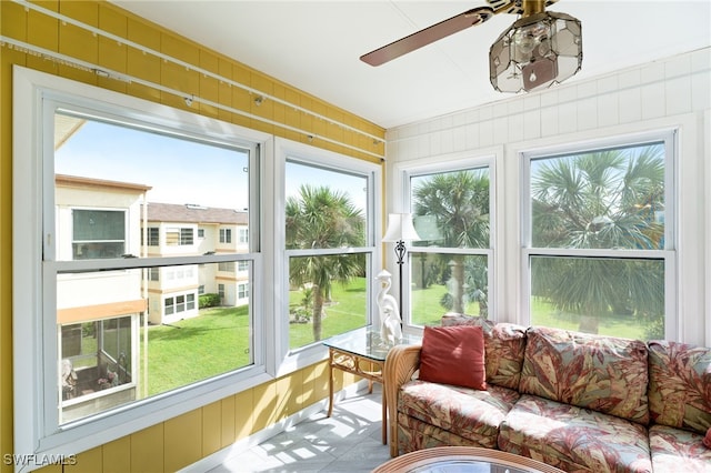 sunroom featuring ceiling fan and a wealth of natural light