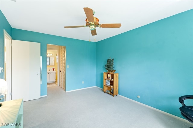 interior space featuring ceiling fan and connected bathroom