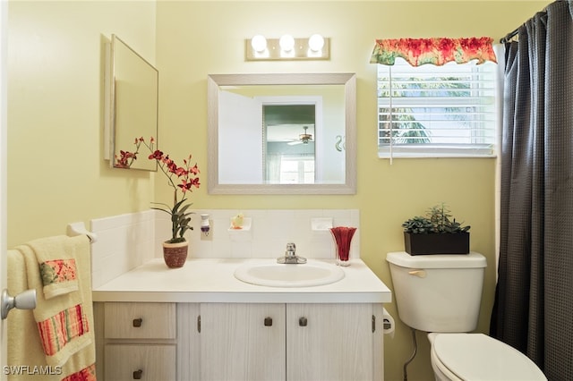 bathroom featuring toilet and vanity