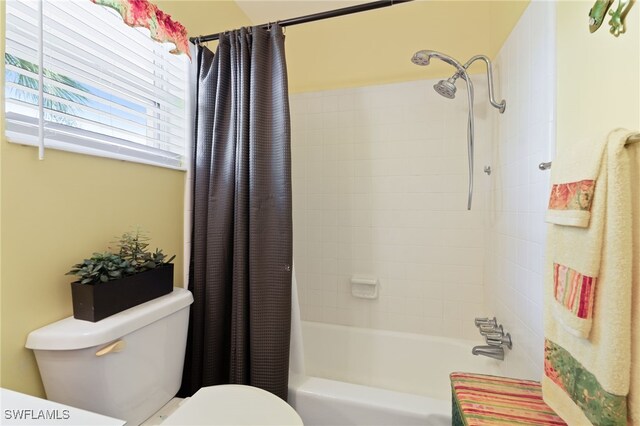 bathroom with toilet and shower / bath combination with curtain