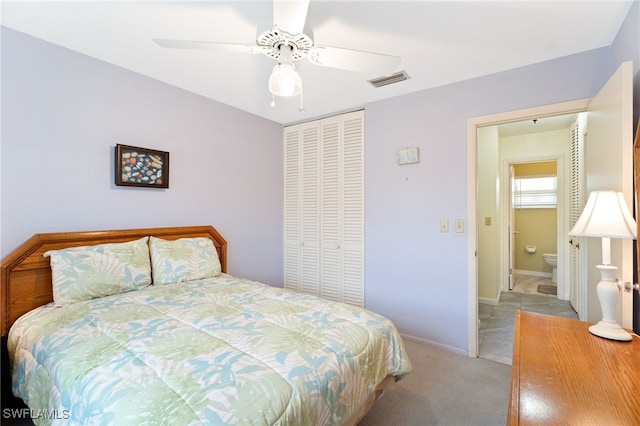 bedroom featuring light carpet, ceiling fan, and a closet