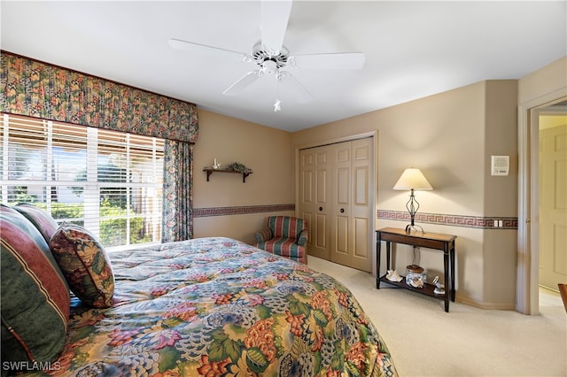 carpeted bedroom with a closet and ceiling fan