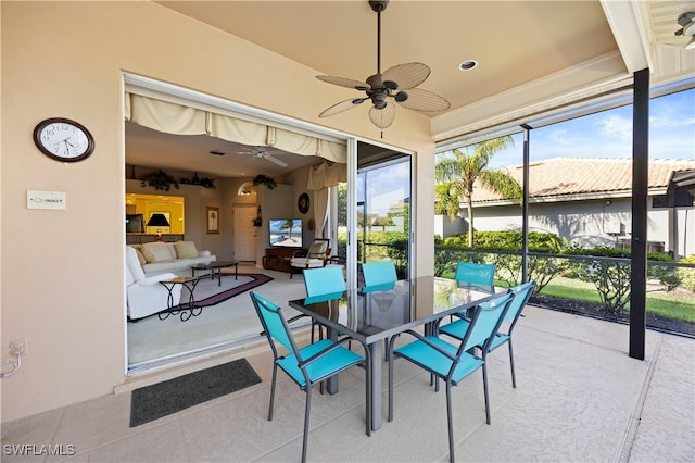 sunroom featuring ceiling fan