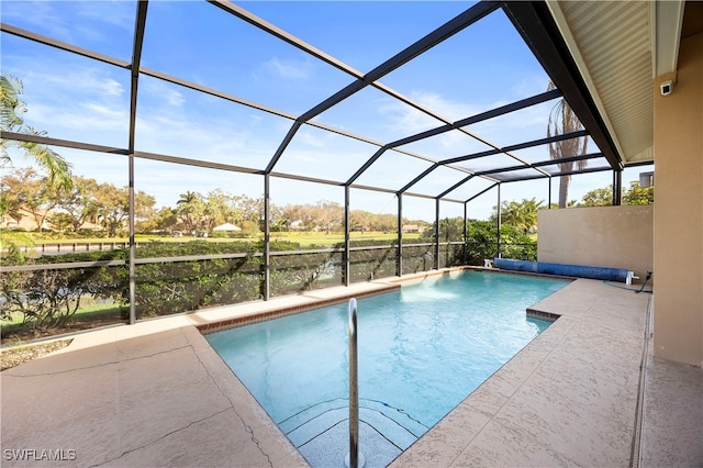 view of swimming pool with glass enclosure