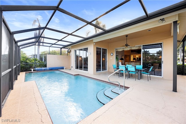 view of pool featuring a lanai, ceiling fan, and a patio