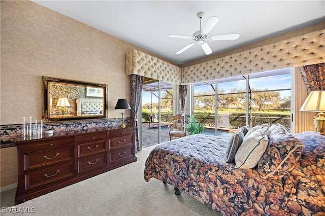 carpeted bedroom with ceiling fan and access to outside