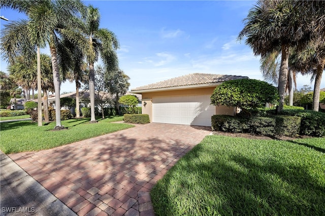 view of front of house with a garage and a front lawn