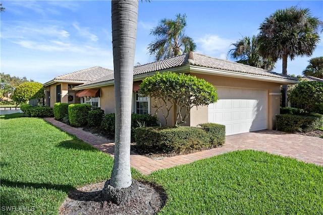 view of front facade with a garage and a front lawn