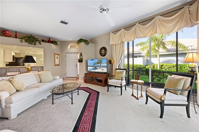 carpeted living room with ceiling fan