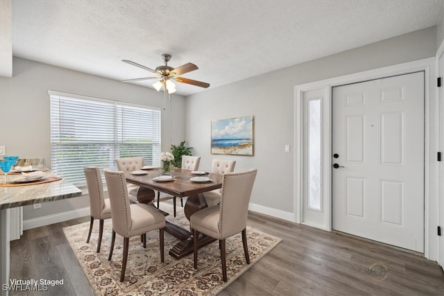 4231 SE 19th Pl Unit 1J, Cape Coral, FL 33904 - dining room featuring wood finished floors, baseboards, ceiling fan, and a textured ceiling