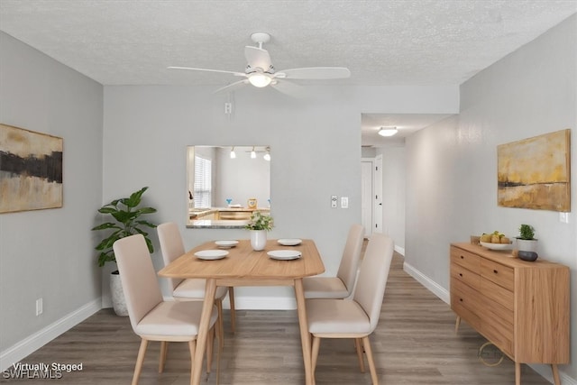 4231 SE 19th Pl Unit 1J, Cape Coral, FL 33904 - dining space featuring wood finished floors, a ceiling fan, a textured ceiling, and baseboards