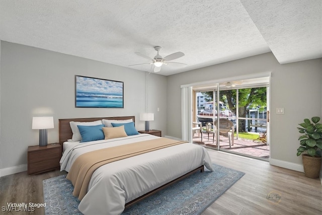 4231 SE 19th Pl Unit 1J, Cape Coral, FL 33904 - bedroom featuring access to exterior, a textured ceiling, wood finished floors, and a ceiling fan