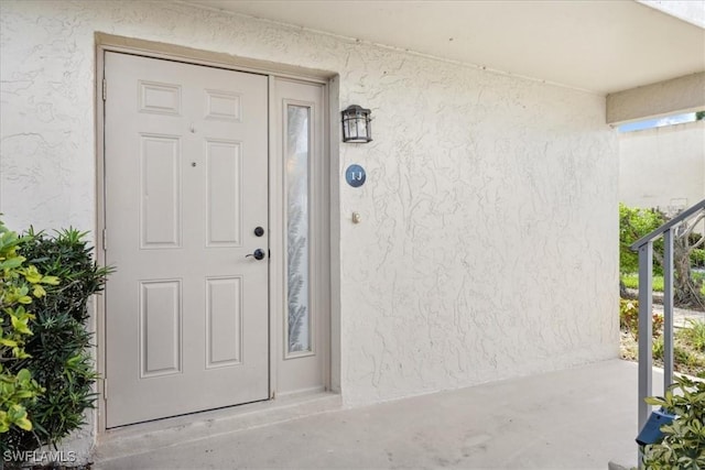 4231 SE 19th Pl Unit 1J, Cape Coral, FL 33904 - doorway to property with stucco siding