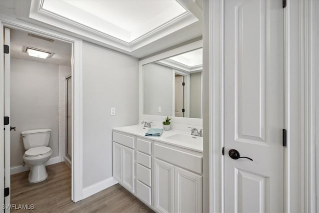 4231 SE 19th Pl Unit 1J, Cape Coral, FL 33904 - full bath with double vanity, toilet, wood finished floors, baseboards, and a shower