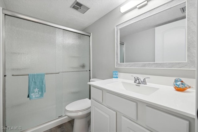 4231 SE 19th Pl Unit 1J, Cape Coral, FL 33904 - bathroom with wood finished floors, vanity, toilet, a shower stall, and a textured ceiling