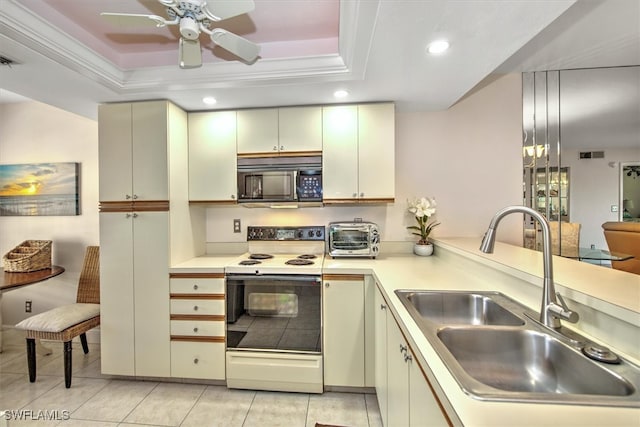 kitchen featuring sink, light tile patterned floors, electric stove, and a tray ceiling