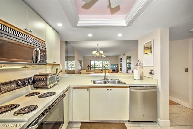 kitchen featuring a raised ceiling, ornamental molding, range with electric stovetop, stainless steel dishwasher, and sink