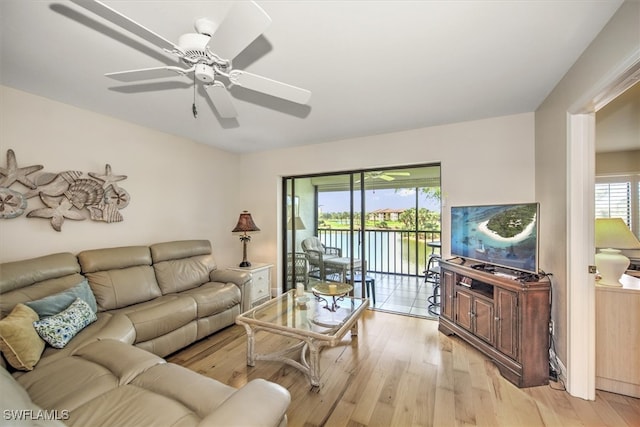 living room with ceiling fan and light wood-type flooring