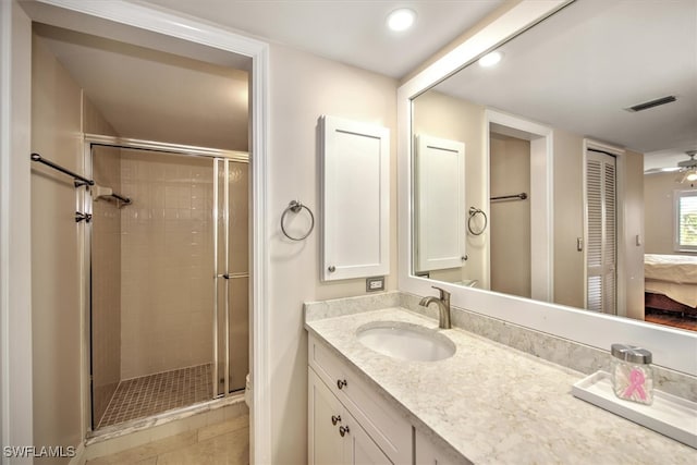 bathroom featuring vanity, tile patterned floors, a shower with shower door, and ceiling fan