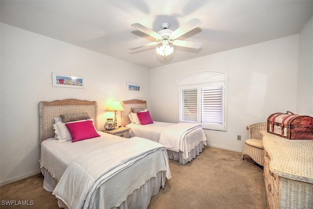 bedroom with ceiling fan and light carpet