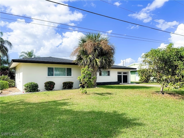 view of front of property featuring a garage and a front lawn