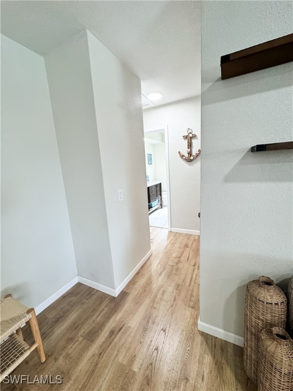 hall with light hardwood / wood-style flooring