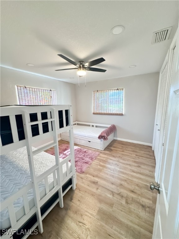 bedroom with ceiling fan and light hardwood / wood-style floors