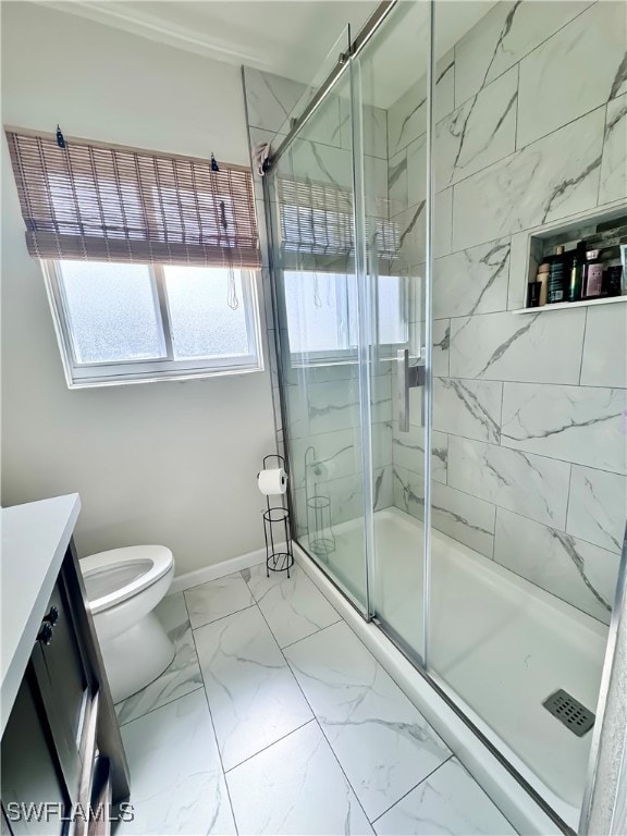 bathroom featuring a shower with door, vanity, and toilet