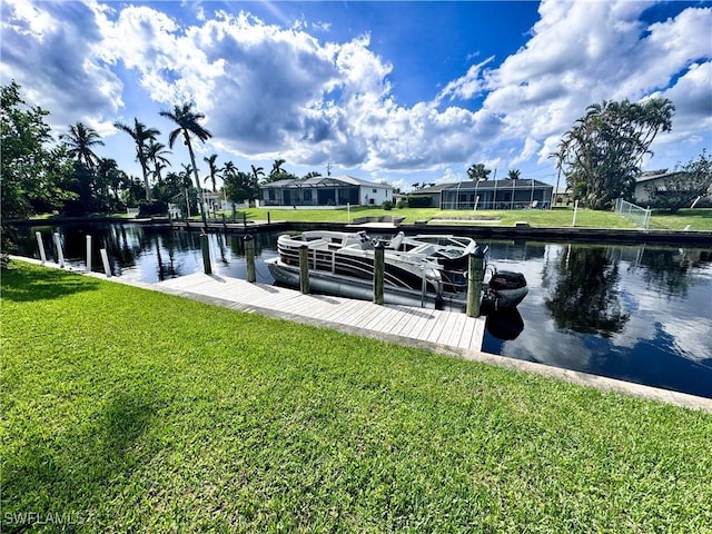 dock area featuring a water view and a lawn