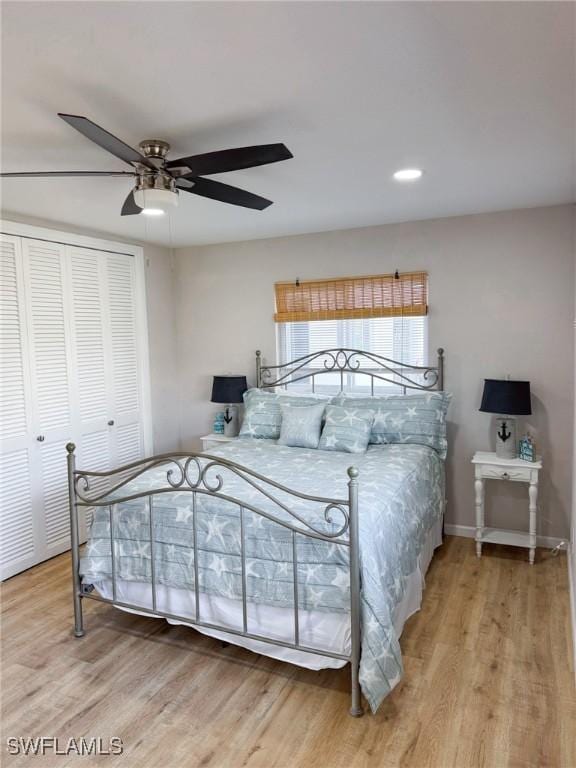 bedroom featuring ceiling fan, hardwood / wood-style floors, and a closet