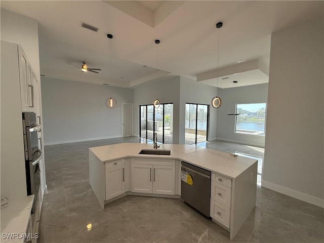 kitchen with stainless steel dishwasher, ceiling fan, sink, decorative light fixtures, and white cabinetry