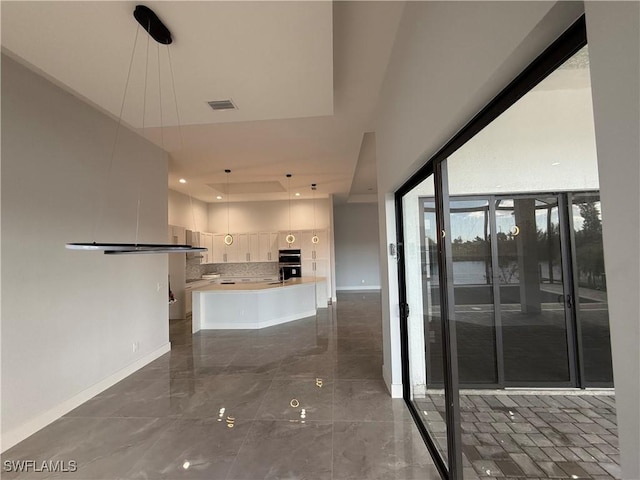 kitchen featuring tasteful backsplash and black double oven