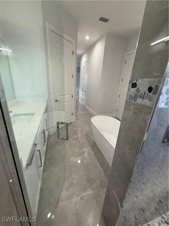 bathroom featuring vanity and separate shower and tub