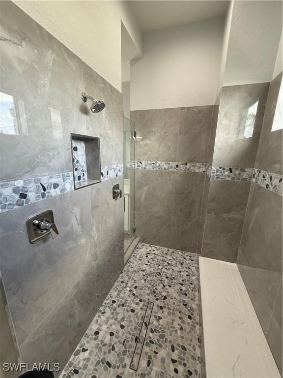 bathroom with a tile shower