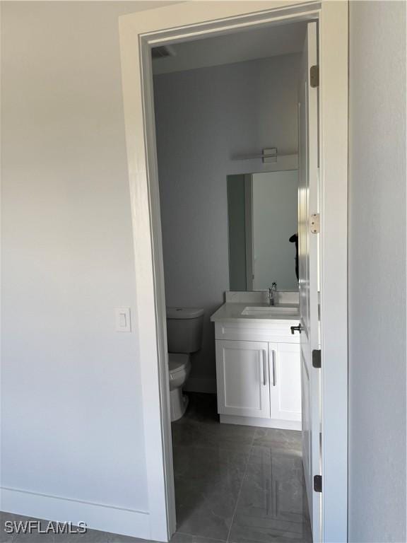 bathroom featuring vanity and toilet